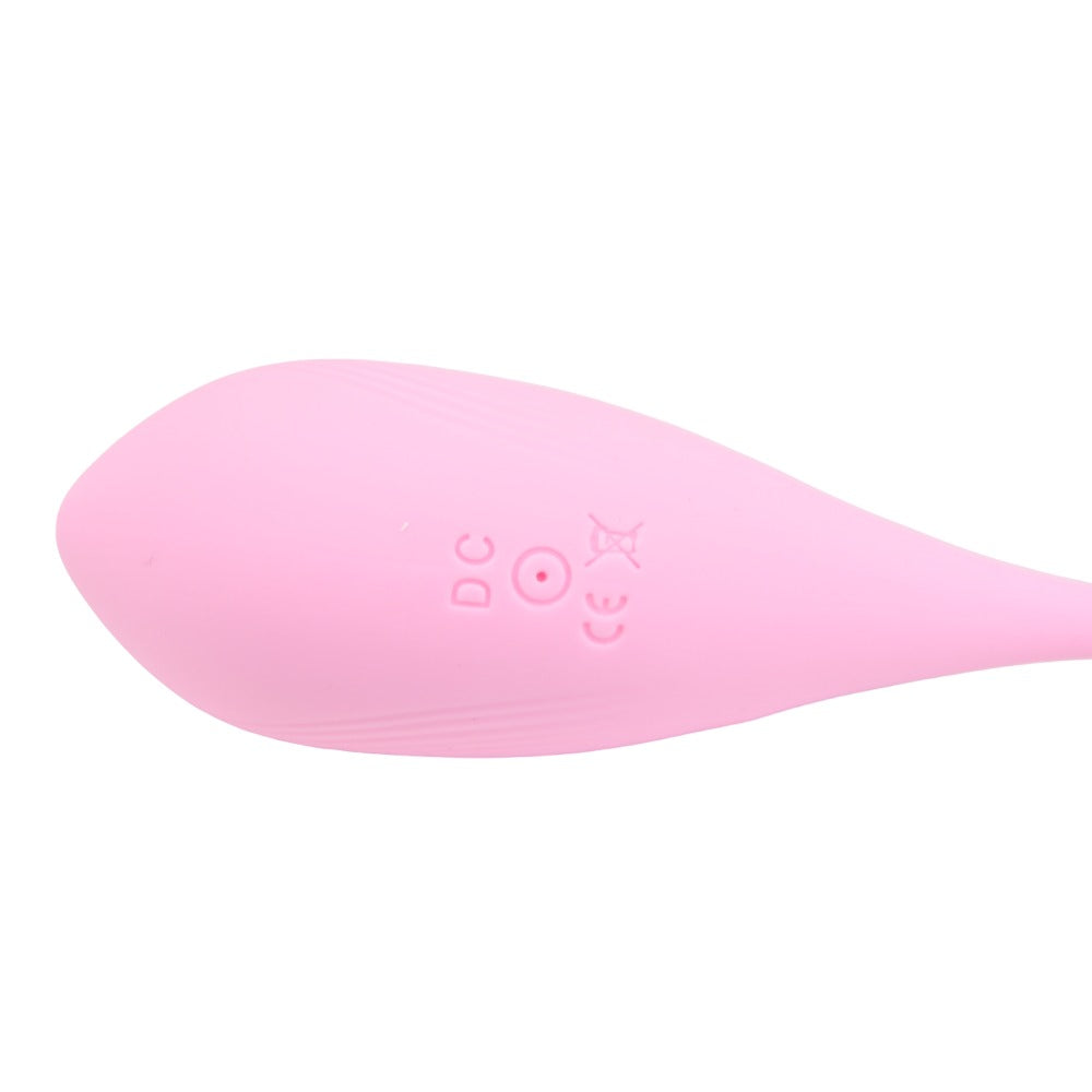 Close-up of the pink, oval-shaped SweetTemptation-Lover's Whisper by My Store, featuring small embossed symbols and letters like DC and CE on its smooth surface. This koppelspeeltje tapers off to the right.